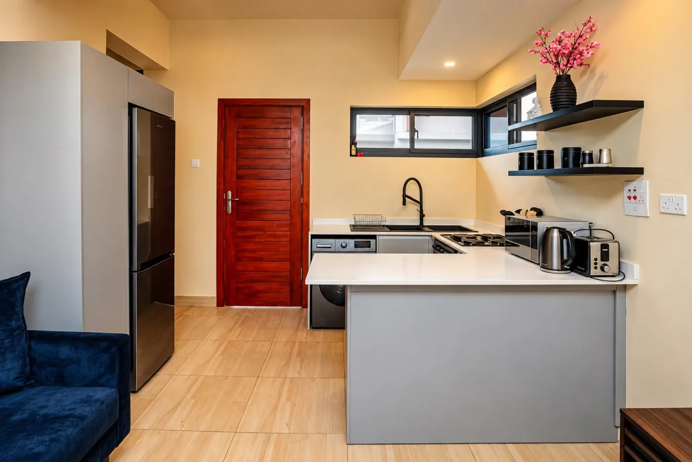 One-bedroom kitchen with fridge, washing machine and stove